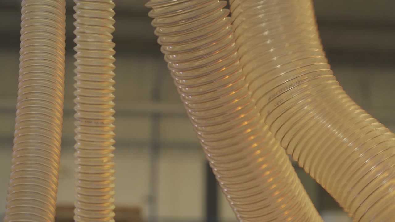 Close up view of flexible duct for industrial extractor working in a factory