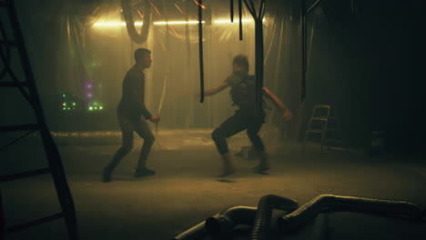 two men fighting in a gritty industrial setting