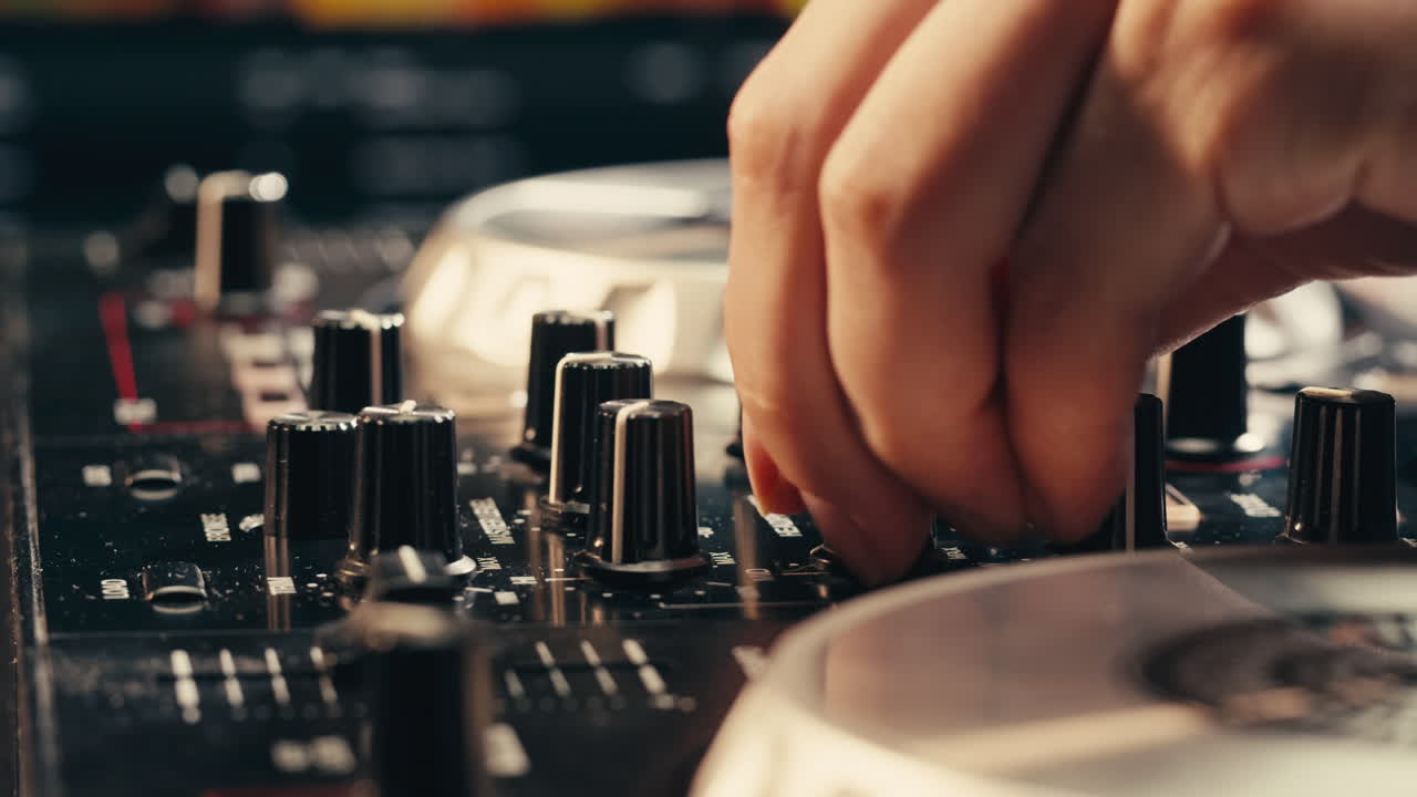 DJ with headphones and sunglasses playing music on festival in night club. Techno musician performing at nightclub for concert crowd of people, city bar.
