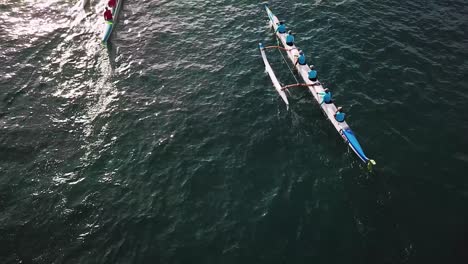 beautiful aerial over many outrigger canoes at the start of a race in hawaii 5