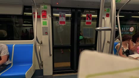 passengers seated as train doors close