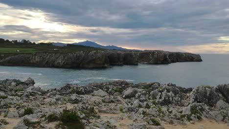 Rocky cliffs at Guadamia and Tuzarrizu, calm sea, cloudy sunset, peaceful vibe