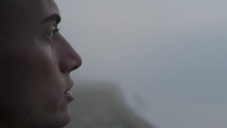 Dreamy-man-enjoying-ocean-landscape-at-sunrise.-Calm-guy-talking-with-himself