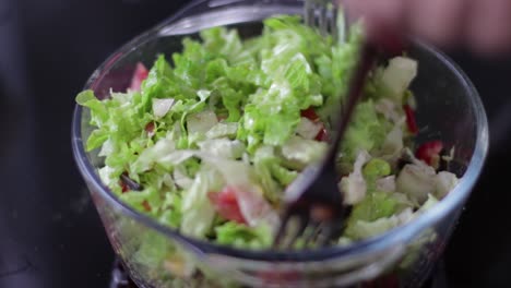 mixing a salad with forks