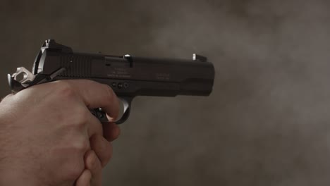 close up of small caliber pistol being fired rapidly in slow motion