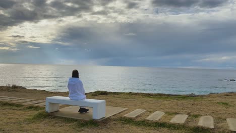 Niña-Sentada-Sola-En-Un-Banco-En-Paphos,-Chipre