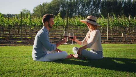 couple enjoying wine in a vineyard