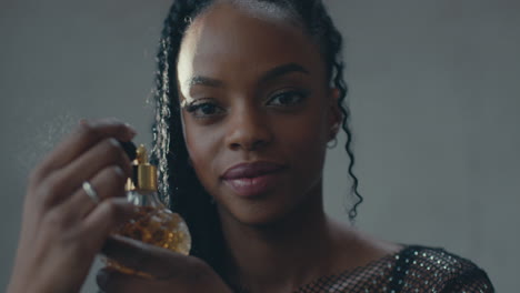 closeup shot of a girl spraying perfume on her