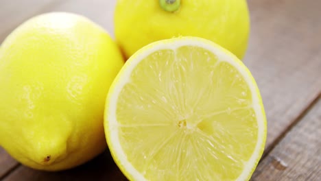 full and half lemons on table