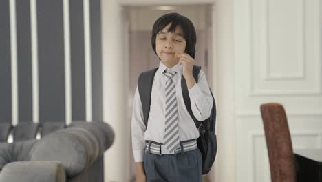 tired and sleepy indian school boy yawning