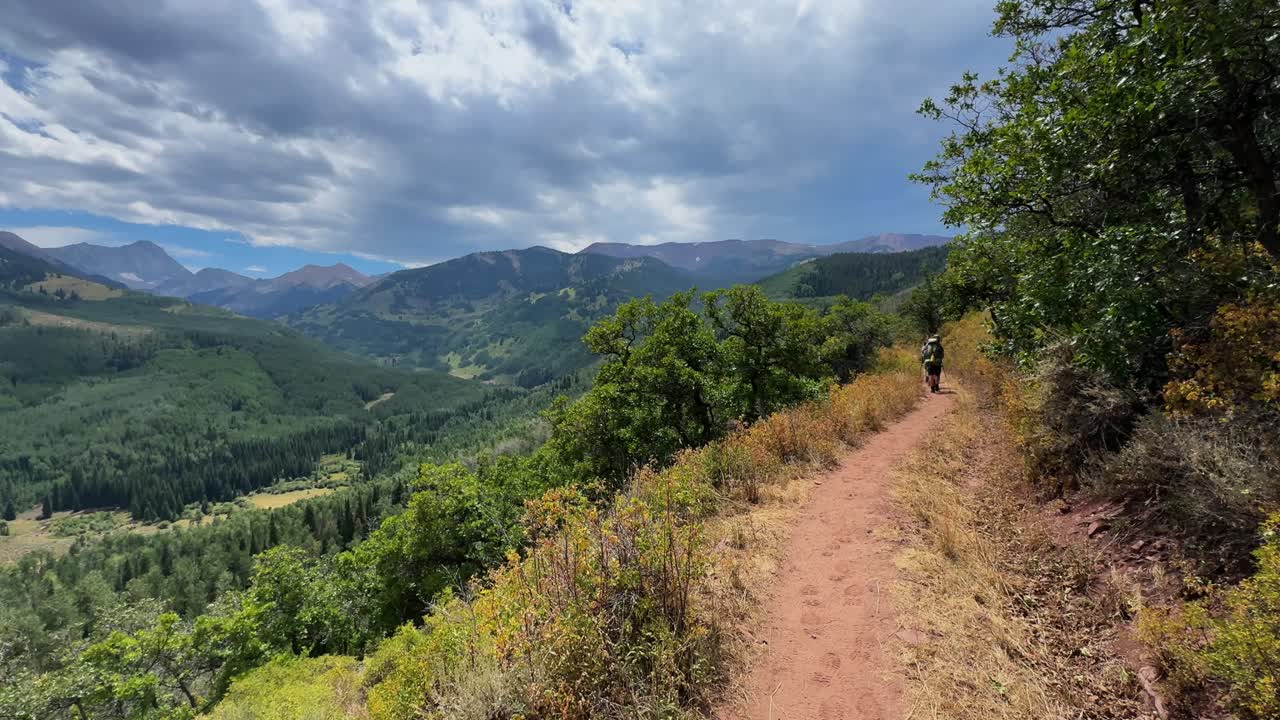 Capitol Peak Trail backpacker hikers people walk Aspen Snowmass wilderness aerial drone White River National Forest spring summer daytime sunny gray cloudy sky Rocky Mountains 14er