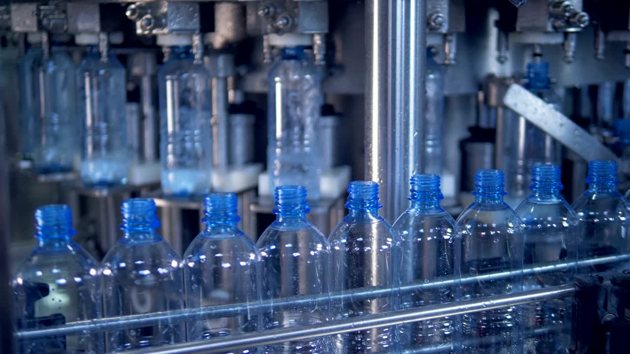 Row plastic bottles at a factory production line. 4K.
