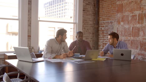 slow motion shot of creative brainstorming meeting in office