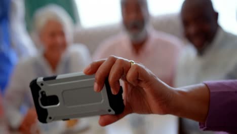 active caucasian senior people taking selfie with mobile phone at nursing home 4k