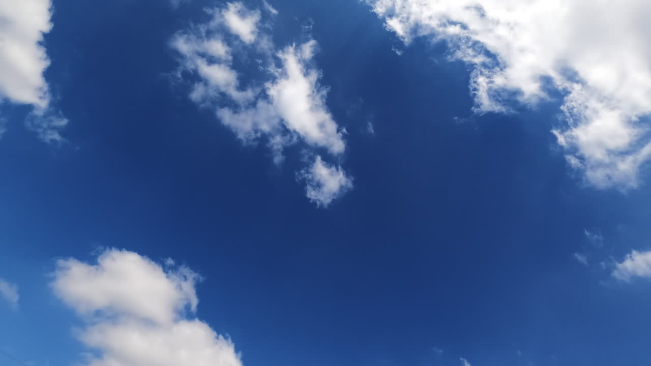 Fluffy white clouds building in the sky. Quick motion time lapse of the summer season bright sky backdrop with beautiful clouds.