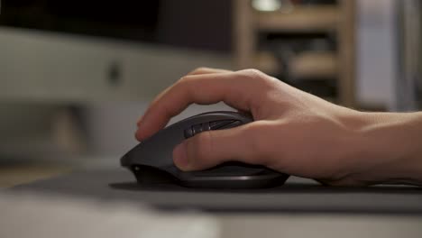 hand moving the computer mouse on the mouse pad - closeup shot