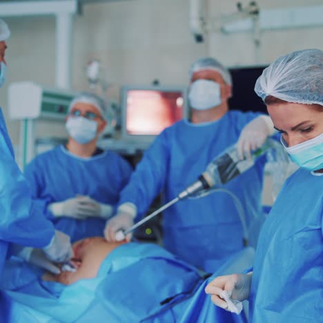 teamwork of professional surgeons. doctors and assistants performing invasive surgery on a patient in the hospital operating room. specialists use modern medical equipment.