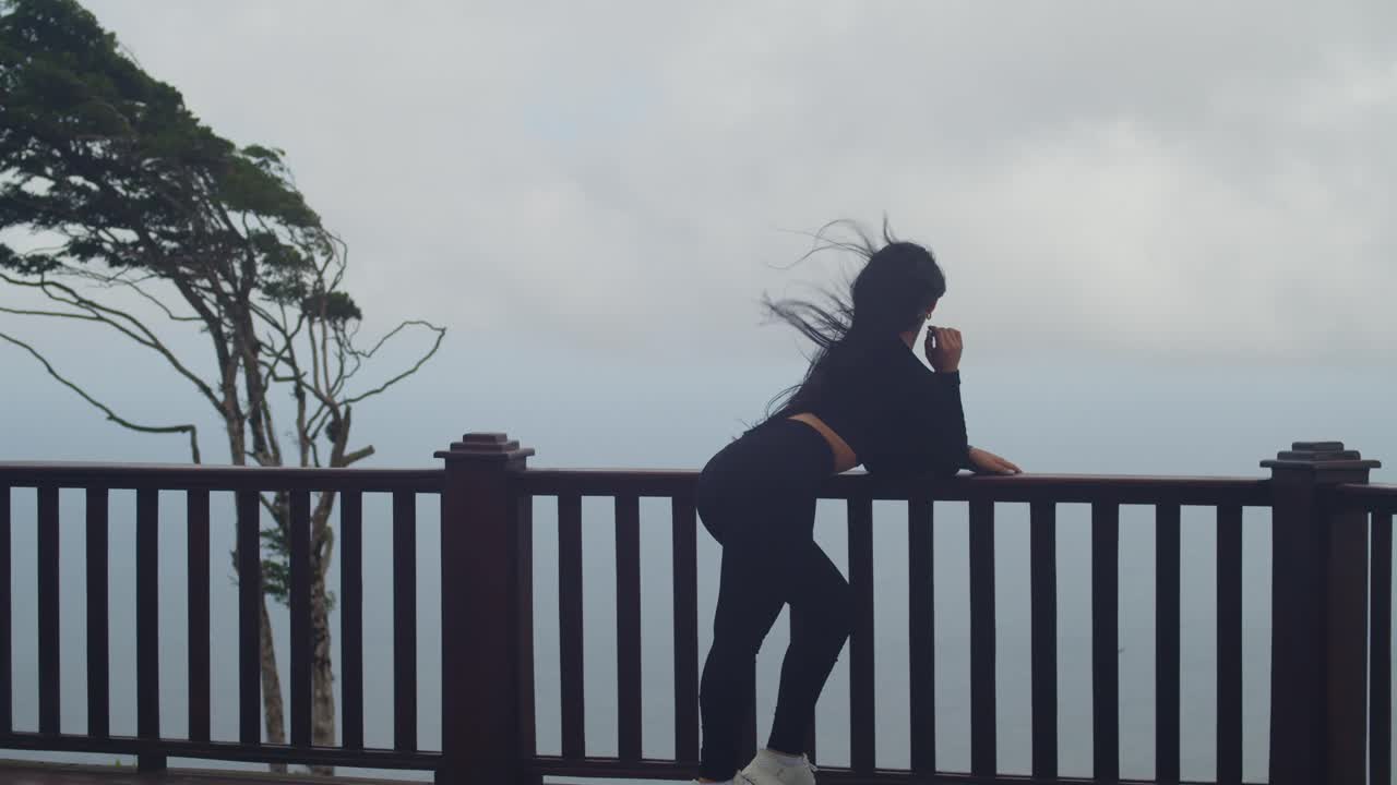 She stands high above the island, savoring the cool breeze and the Trinidadian sea view at La Vigie