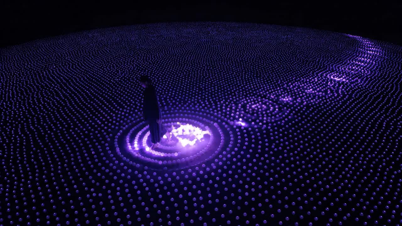 Person Interacting with Futuristic Purple Light Art Installation