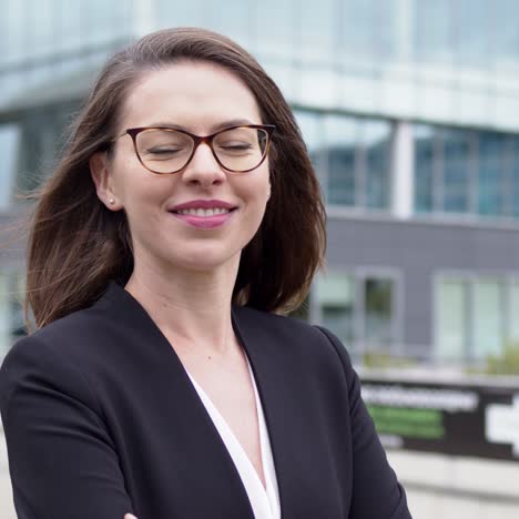 smart business woman standing over modern building