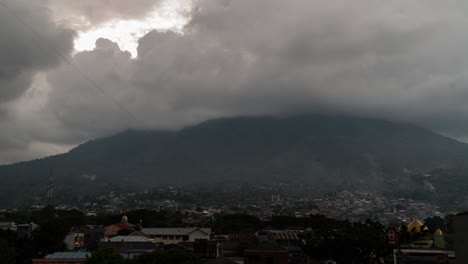 cloud-covered mountain and town