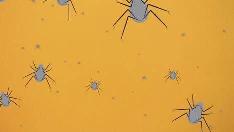 animación de arañas que caen sobre un fondo naranja