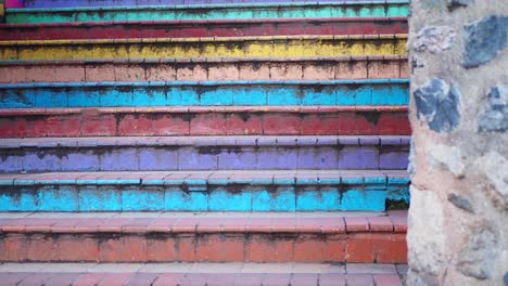 colorful steps up a stone wall