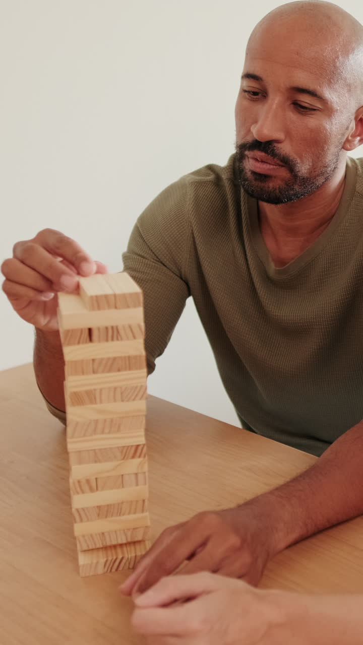 Couple Having Fun Playing Jenga at Home