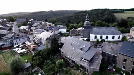 pull-away aerial shot of rochehaut village in belgium ardennes in green mountains