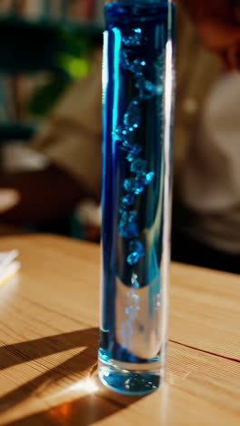 young person conducting a science experiment with a test tube at home