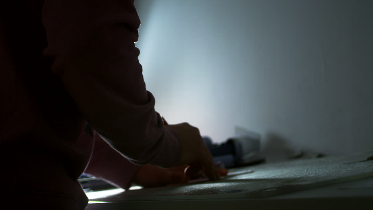Leather worker with knife creating leathercraft pattern.