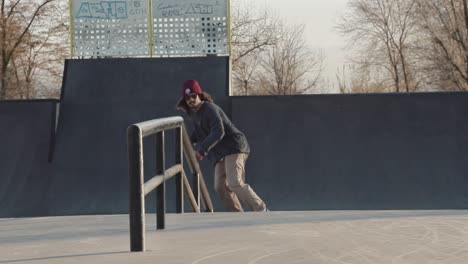 close shot in slowmotion of a skateboarder doing a frontside board slide with rotation out on the last lights of the day.