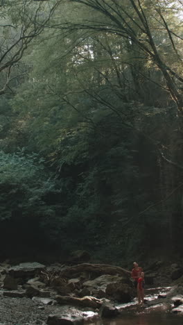 family enjoying a nature walk in a forest stream