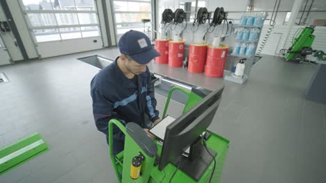 automotive technician working on diagnostics in a garage