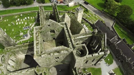 Aerial-drone-shot-of-castle-and-grassy-landscapes-in-Ireland