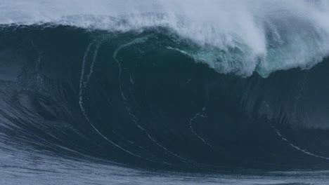 telephoto slow motion closeup of strong ocean wave lip face rising crashing into glass water