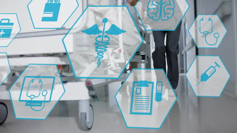 animation of medical icons over doctors walking with hospital bed
