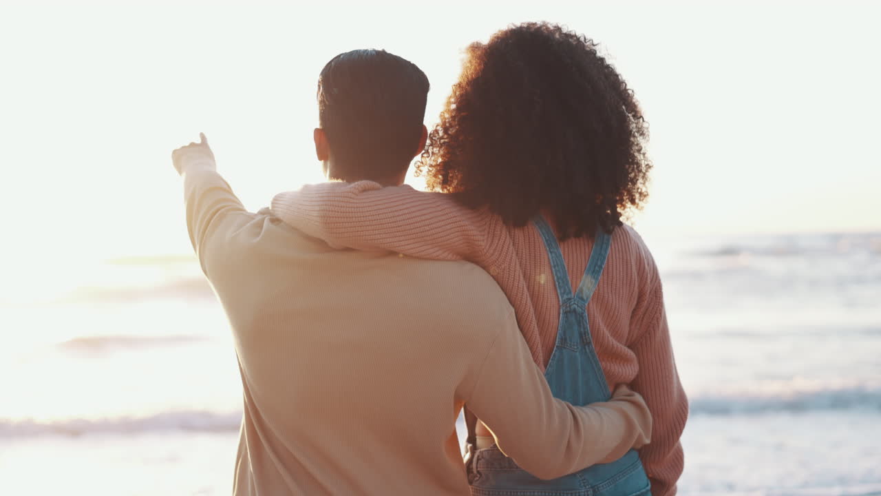 Couple, hug and beach, pointing at view