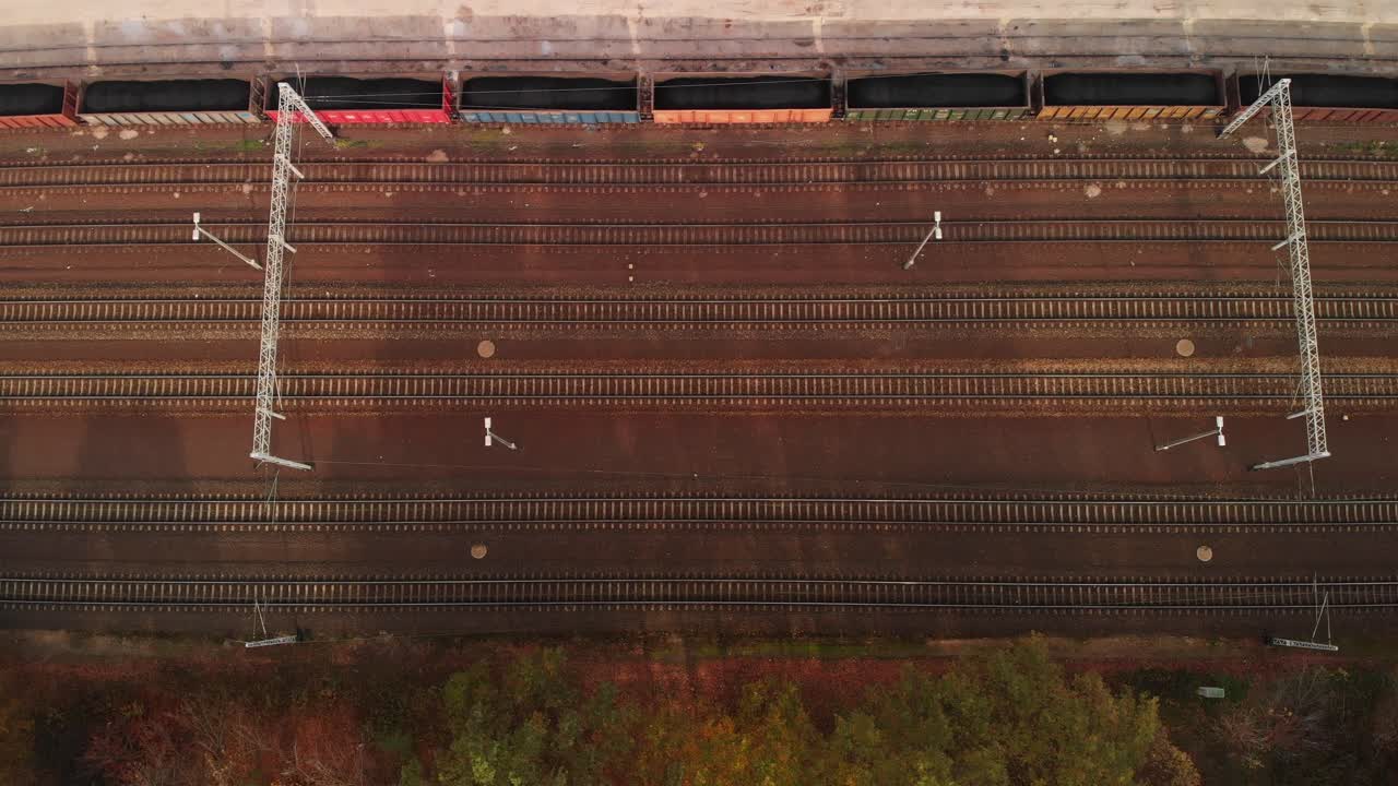 Aerial top down establishing shot of many rails and trains in a rail terminal