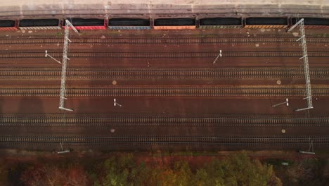 aerial top down establishing shot of many rails and trains in a rail terminal
