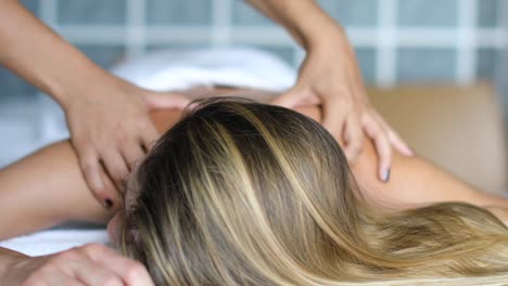 young woman getting a massage in a spa