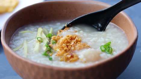 eating porridge with toppings, spoon stirring