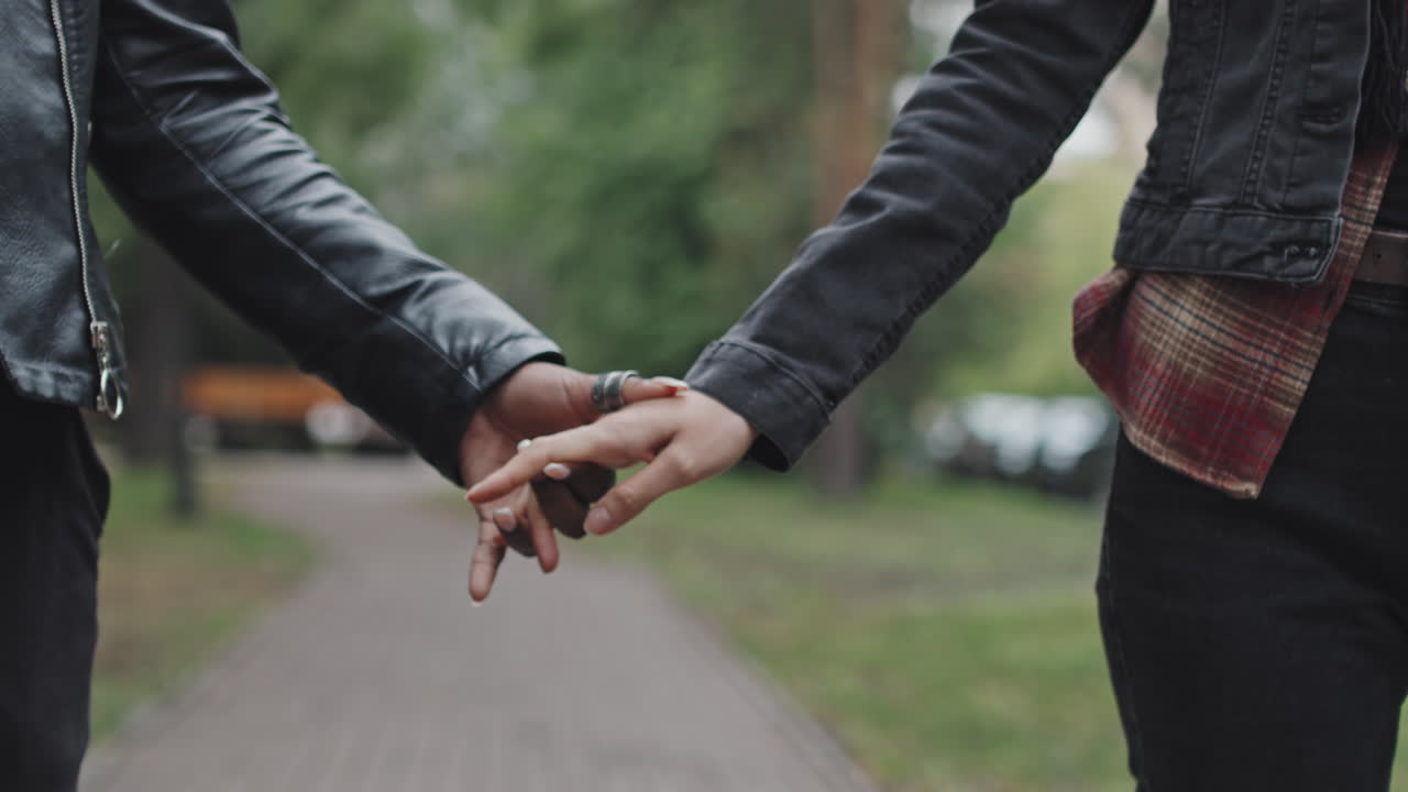 Close Up of Lesbian Couple Holding Hands and Walking