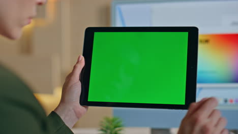 startuper using greenscreen tablet in office close up. unrecognizable designer