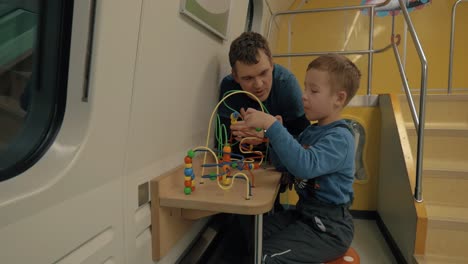 dad and son spending time in train play room