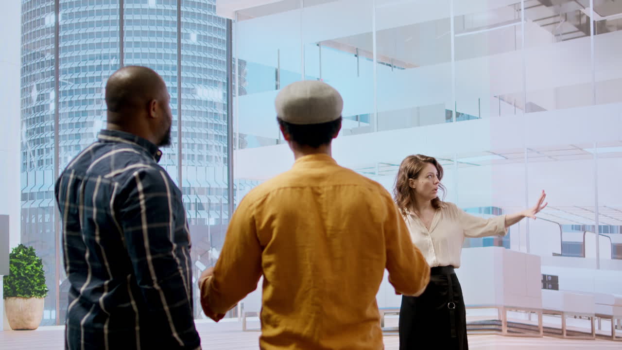 Business professionals and real estate agent evaluating detailed blueprints