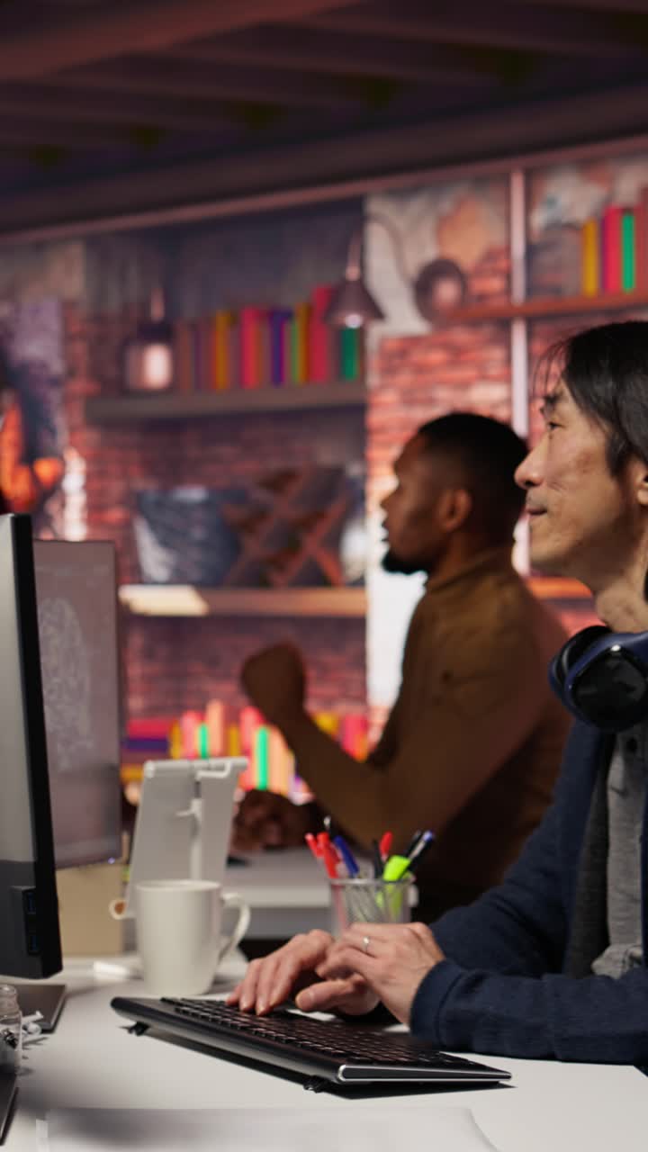 Vertical video AI startup intern holding laptop asks questions to senior technician