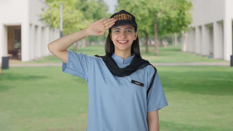 happy indian female security guard saluting