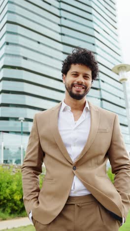 man in suit posing in front of building