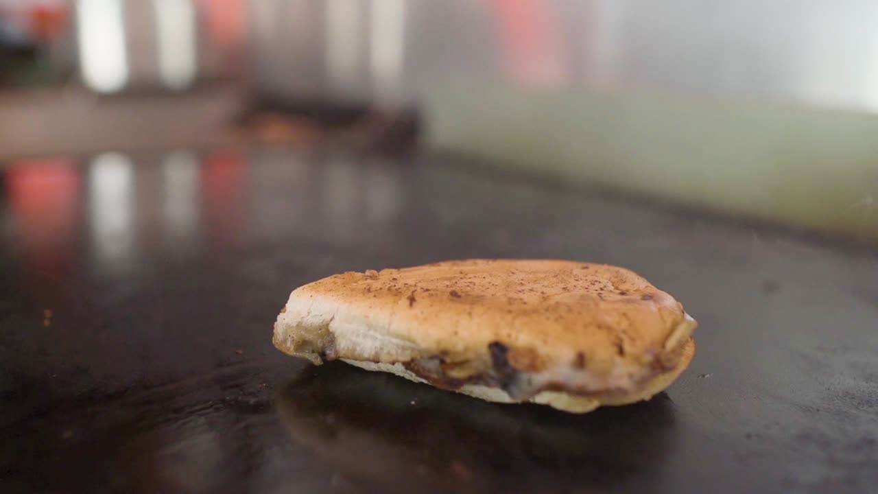 Cooking a delicious bread with meat and cheese grilled